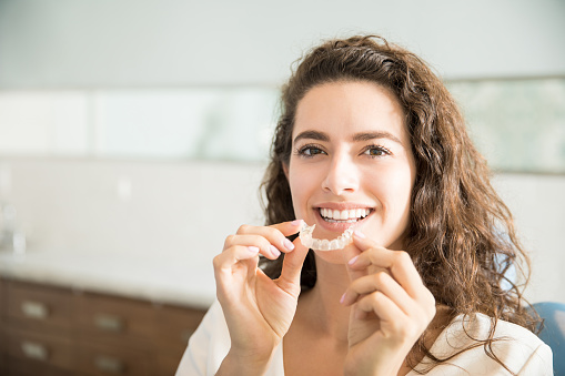 Woman holding SureSmile Clear Aligners from Radiance Dental in West Chester, PA