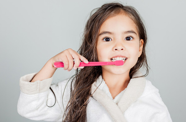 Young girl brushing her teeth at Radiance Dental in West Chester, PA